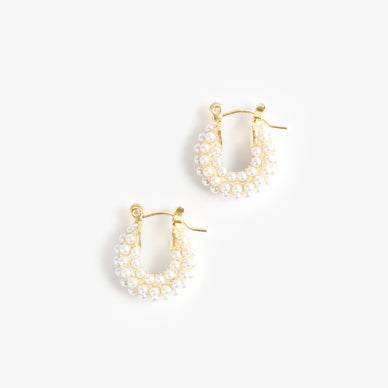 Fulfilled by our friends at Marrin Costello The It Hoop for girls that get it — meet our second edition of the Audrey Collection, detailed with ivory glass pearls. Available in both Hoop and Huggie sizes, this clickhoop earring is the statement you never knew you couldn't live without. Small in diameter but big in statement — Audrey is light (and small) enough to wear every single day, and yet sophisticated enough to rock with formal attire. Named one part for Ms. Hepburn herself and two part for Ms. Audrey Hope, the designer's soul coach and guest on Season 1 of the Marrin Costello Radio podcast — the Audrey's are stunning just as much as they are meaningful. From brunch to prom to bridal galore and everything in between — this hoop is not a want but a need. Click-back closure — for pierced ears 0.5" diameter *Please Note: Rewards cannot be applied to this product This item is not eligible for returns This item cannot be shipped outside the U.S.