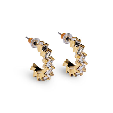 Discover a new twist on timeless elegance with our Zigzag Eternity Hoop Earrings, an updated version of our beloved small gem eternity hoops. These earrings combine the same lightweight comfort and classic size with a modern zigzag design, ensuring you stand out with every wear. 14K Gold over Brass available in Crystal, Green Pink 16mm Hoop Fulfilled by our friends at Short Suite *Please Note: Rewards cannot be applied to this product This item is not eligible for returns This item cannot be shipped outside the U.S.