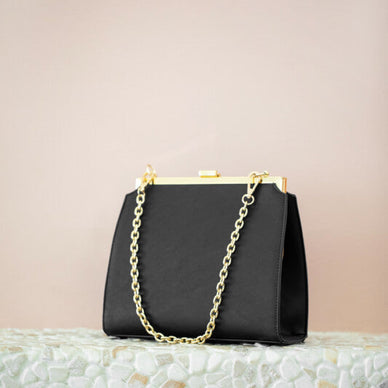 Handcrafted 100% with Waterborne PU. 
An elegant companion that can also be your everyday style! Our Nicky bag is constructed with a delicate frame and complemented with a gold chain strap. Beautiful inside zipper and slip pocket. Included, a detachable crossbody strap. 
Size: 9”H x 9.5”L x 3.5” D 
Fulfilled by our friends at SHOP AOTA 

*Please Note: 

This item is not eligible for returns 
This item cannot be shipped outside the U.S.
