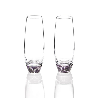 While designed to hold bubbly, our Elevo champagne glasses welcome all sorts of beverages. Expertly crafted from lead-free European crystal inset into semi-precious gemstones, these glasses will elevate your bar and your attitude (especially after hours of Zoom meetings). 

Set of 2
Smoke Agate, Amethyst Lead-Free Crystal
Made in Poland
Each glass is unique in color, shape and pattern
Hand wash with mild soap
2.25" x 2.25" x 6" / 8cm x 8cm x 15cm

Healing Properties 
Our gemstone champagne glasses are sculpted from Agate, thought to encourage calmness and peace. Our crystal champagne glasses are also made from Amethyst, believed to confer power and strength. In the Middle Ages, Amethyst was a symbol of royalty, used to decorate crowns and scepters. Our modern designs are believed to enhance your home for generations to come. 
Fulfilled by our friends at ANNA NEW YORK 
*Please Note: This product cannot be shipped outside of the U.S. 