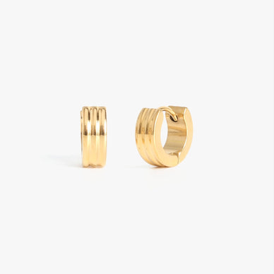 Timeless meets texture in our Petra Huggies. Featuring a ribbed design, this stainless steel style is lightweight yet luxe. Delicate but durable, this huggie earring is just a shy wider than our Orion Huggies — an amazingly multifaceted size that can be worn in any ear piercing hole — from lobe to cartilage alike. Available in both 3mm and 5mm width for your ear stacking pleasure. Designer tip: give this simple and chic set of huggie earrings as a gift knowing that they hypoallergenic and water resistant — fit for every earlobe. 

Click tension hinge closure — for pierced ears
1.25" diameter
3mm width

Fulfilled by our friends at MARRIN COSTELLO 

Please Note: Rewards cannot be applied to this product 