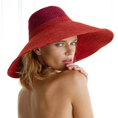 Riri 'Duo' hat is perfect for packing on your next tropical vacation. It's made from the union of maroon and red jute colors that's bold yet versatile. Made by our female artisans in Bali from natural jute straws, it has a sculpted crown and a brim that shields from the sun. 
DETAILS - Dimension: Brim 6 inches approximately - Composition: 100% Natural Jute 
SUSTAINABILITY VALUES - Ethically made in Bali - Biodegradable - Made from natural jute straws - Plant-based 
Fulfilled by our friends at BrunnaCo 

Please Note: Rewards cannot be applied to this product 