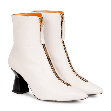 Get ready for winter fun. Walk a little taller in these beautiful Rose off-white leather ankle boots. The front chain on these pointed boots is the perfect way to add a little glam to your everyday look. Featuring front zip closure, a pointed toe, off-white leather upper, leather lining, and branded leather insole. The slip-on boot sits on a sculpted heel. Pair with a cute day dress and kill it! 
 Brand: Saint G 
Color: Off White 
Closure: Slip On 
Upper: Sheep Nappa 

Lining: Sheep Nappa 
Sock: Sheep Nappa 
Outsole: Tunit 
Material: Nappa 
Heels: 3 Inches 
Fulfilled by our friends at FutureBrandsGroup 




